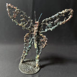 Sculpture de Philippe Buil représentant un papillon en dentelle de métal, symbole de légèreté et de transformation.