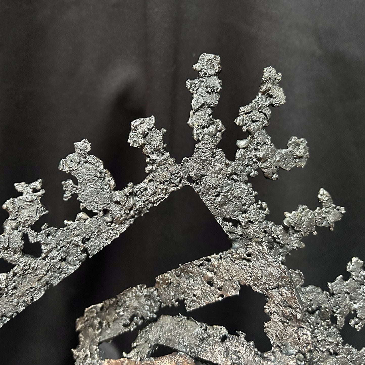 Détail de la dentelle d'acier de la sculpture Les Carrés du Secret par Philippe Buil