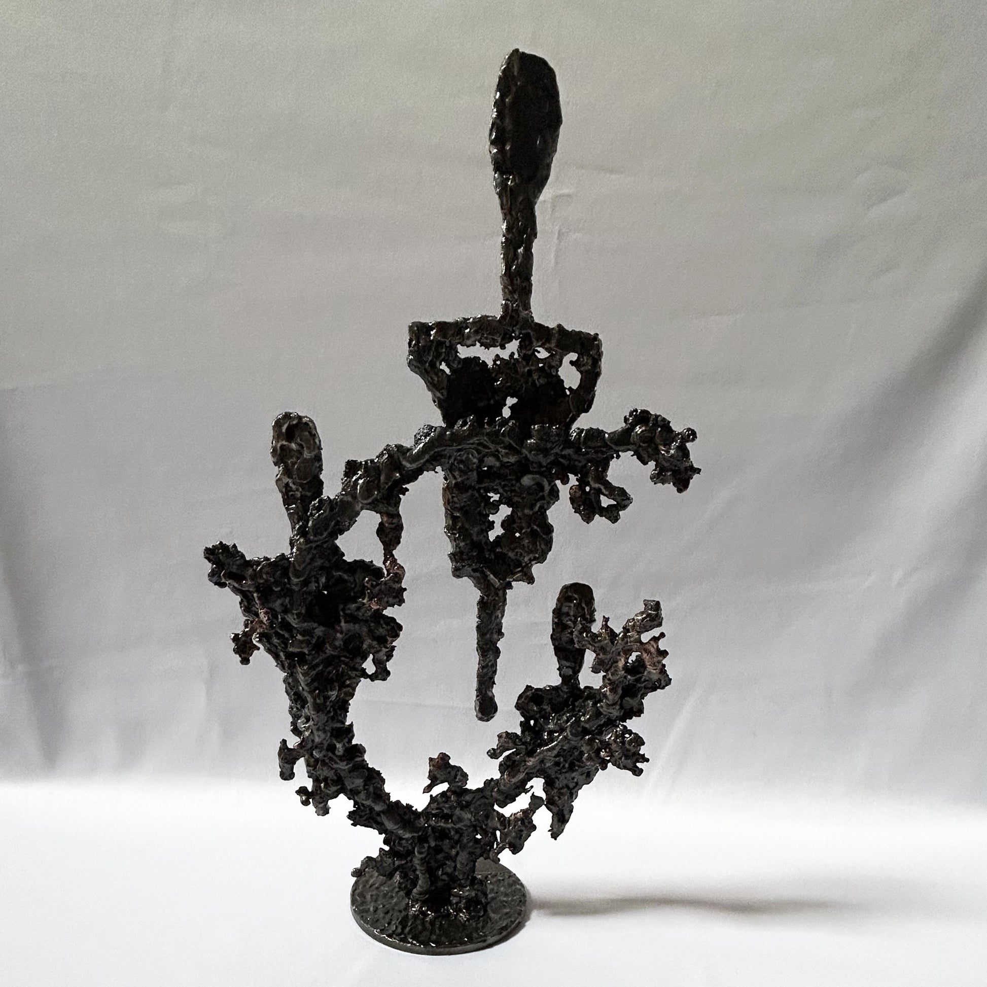 Cette sculpture de Philippe Buil, inspirée par Fernand Léger présente une composition abstraite et aérée, évoquant des figures spectrales ou des formes humanoïdes stylisées.
