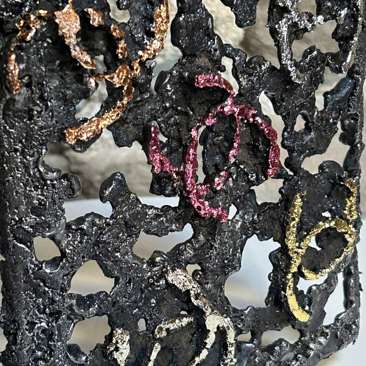 Finition métallisée rosée d'un logo sur la sculpture Chanel N°5 de Philippe Buil