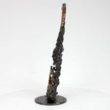 Sculpture de Philippe Buil représentant une bouteille de champagne en dentelle de métal : acier et bronze