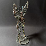 Sculpture de Philippe Buil représentant un papillon en dentelle de métal, symbole de légèreté et de transformation.