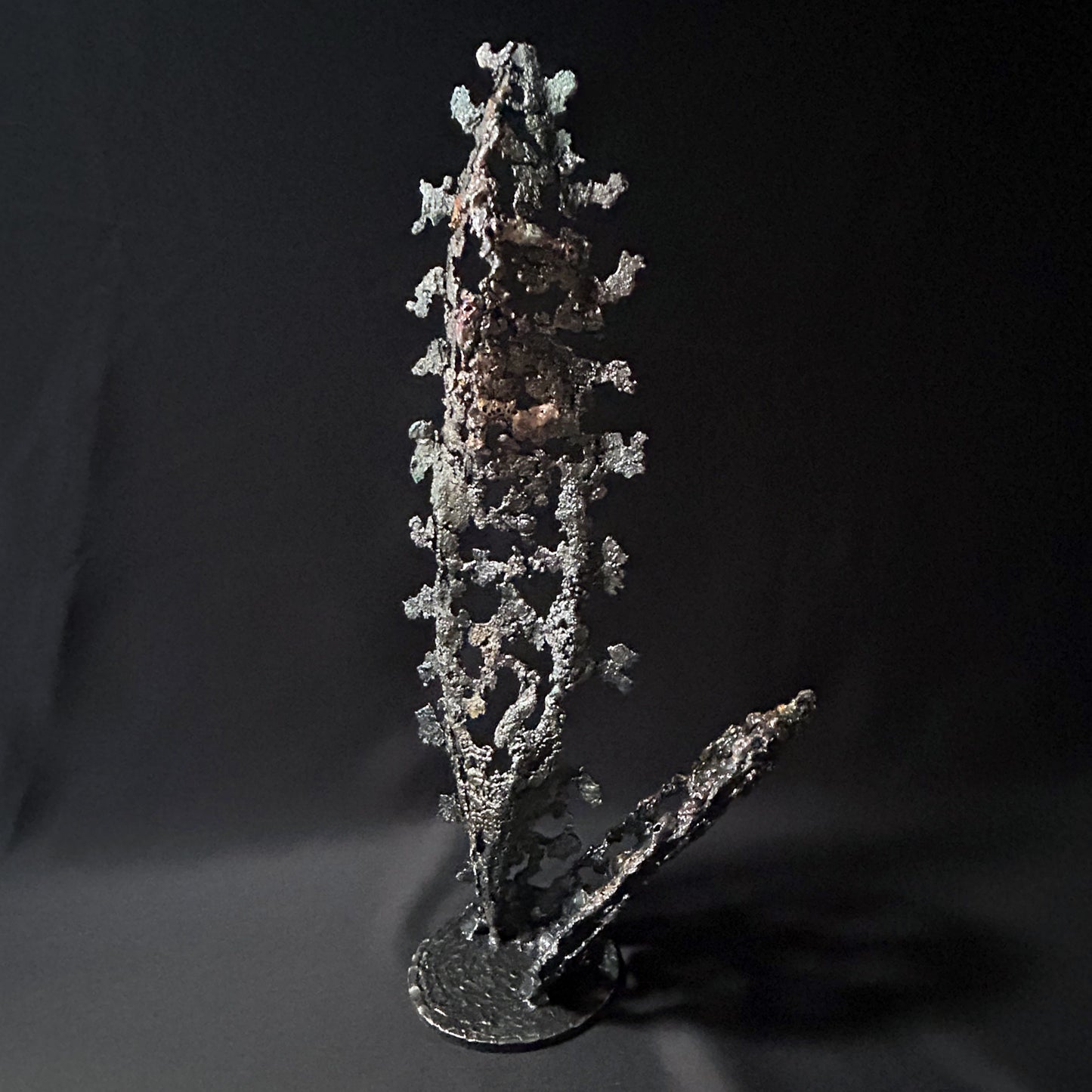 Sculpture abstraite de Philippe Buil : dentelle de métal en acier et bronze, reflets irisées et formes ajourées, œuvre unique contemporaine.