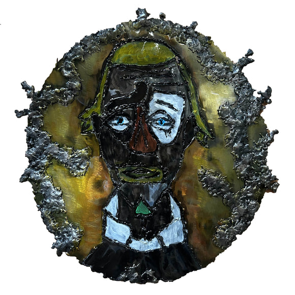 Sculpture murale en acier réalisée par Philippe Buil, représentant un visage de clown inspiré de Bernard Buffet, avec dentelle de métal et pigments colorés.