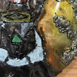 Sculpture murale en acier réalisée par Philippe Buil, représentant un visage de clown inspiré de Bernard Buffet, avec dentelle de métal et pigments colorés.