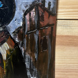 Tableau mural de 25×25 cm représentant un chat à béret dans un décor urbain gris et texturé. L’œuvre est réalisée en métal découpé avec des zones de dentelle de métal et colorée avec des pigments, créant un effet expressif et contrasté.